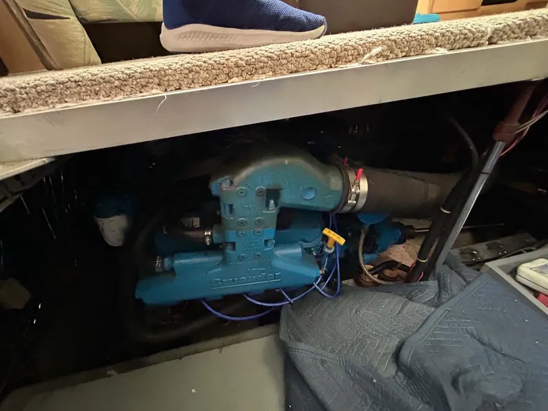 Slide: The Image of Engine compartment of a 1995 Carver 370 Aft Cabin boat, partially visible under flooring. - 27