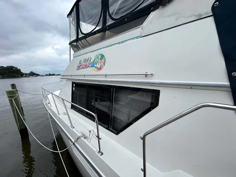 Slide: The Image of 1995 Carver 370 Aft Cabin yacht docked by the water. - 34