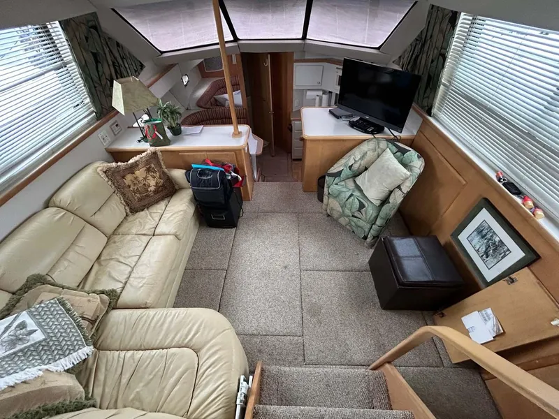 Slide: The Image of Interior of 1995 Carver 370 Aft Cabin yacht with cozy seating and modern amenities. - 4