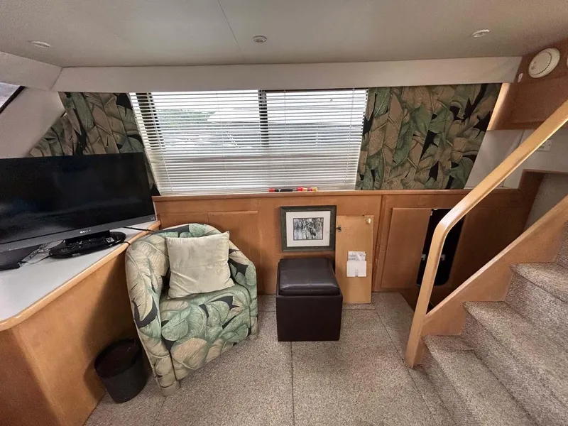 Slide: The Image of Interior of 1995 Carver 370 Aft Cabin with chair, TV, and stairs. - 6