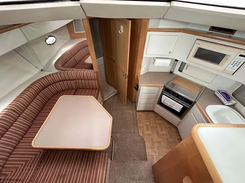 Slide: The Image of Interior of 1995 Carver 370 Aft Cabin with kitchen and dining area. - 7