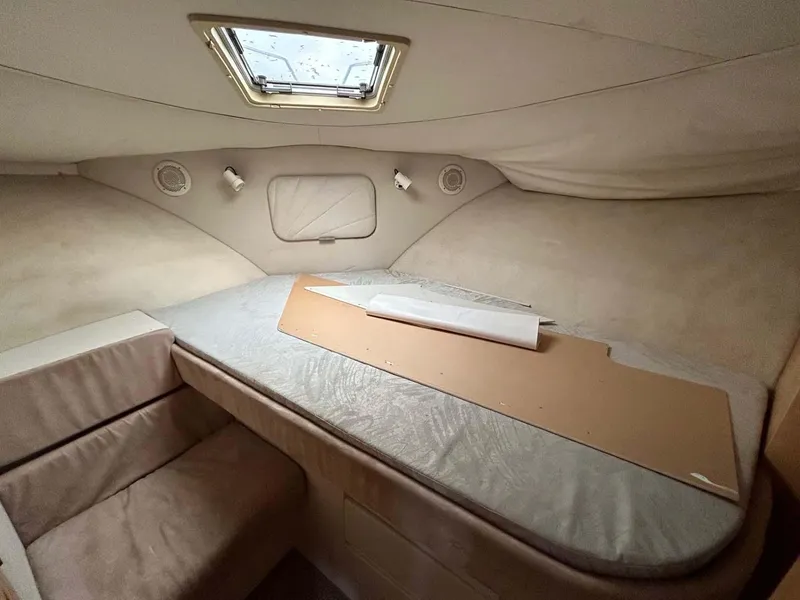 Slide: The Image of 1995 Carver 370 Aft Cabin interior with bed, skylight, and beige upholstery. - 9