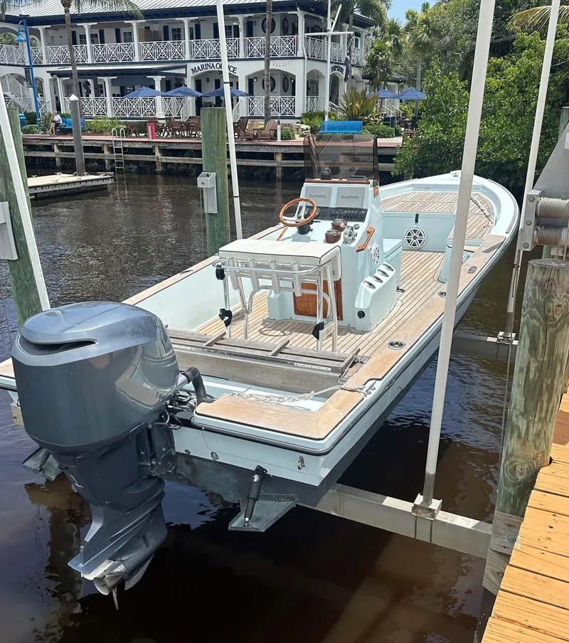 Slide: The Image of 2004 Pathfinder 2400 V boat docked at marina with outboard motor. - 10