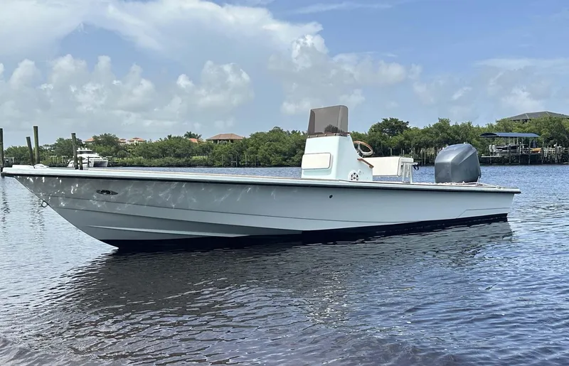 Slide: The Image of 2004 Pathfinder 2400 V boat on calm water under a clear sky. - 11