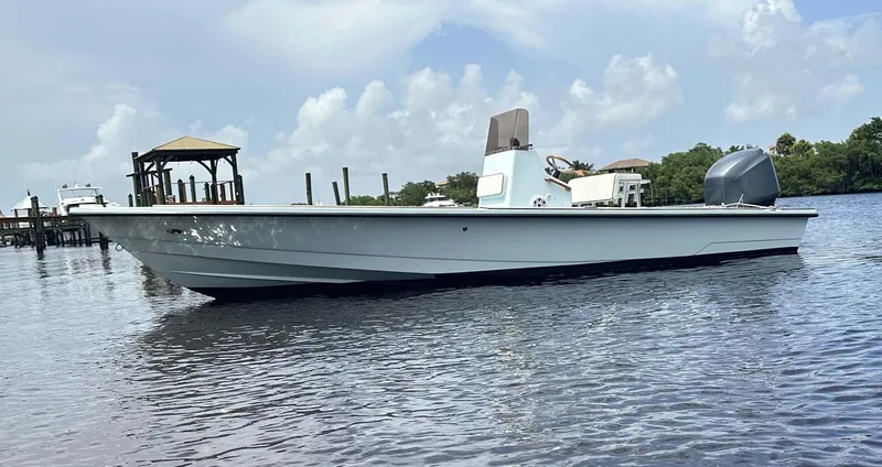 Slide: The Image of 2004 Pathfinder 2400 V boat on calm water, clear sky background. - 12