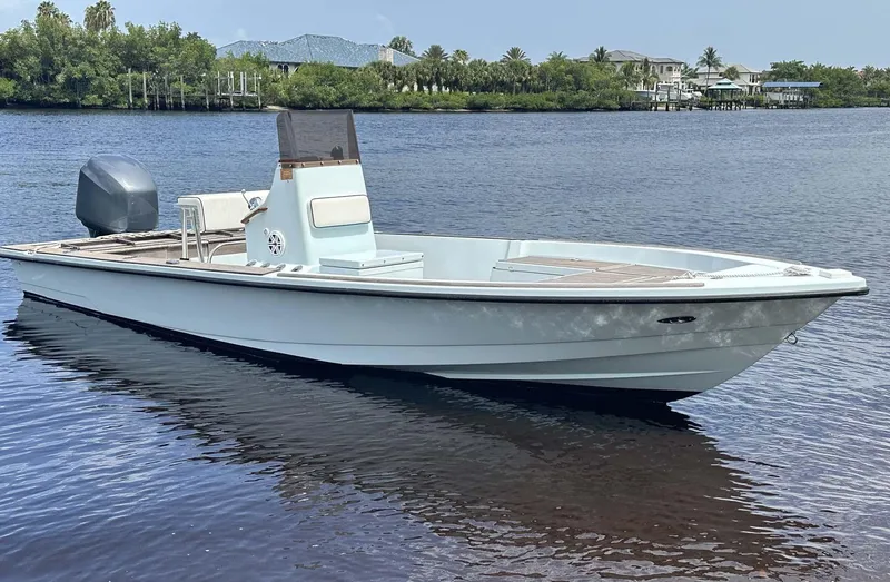 Slide: The Image of 2004 Pathfinder 2400 V boat on calm water, scenic background. - 13