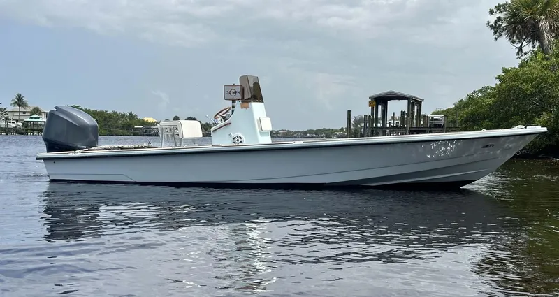 Slide: The Image of 2004 Pathfinder 2400 V boat on calm water near a dock. - 14