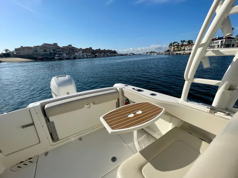 Slide: The Image of 2018 Boston Whaler 230 Vantage boat interior with scenic waterfront view. - 13