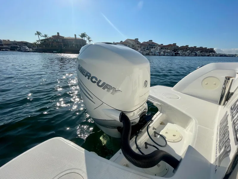 Slide: The Image of 2018 Boston Whaler 230 Vantage with Mercury outboard engine on sunny waterfront. - 15