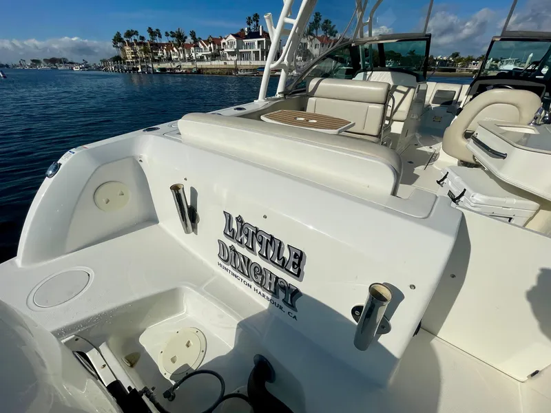 Slide: The Image of 2018 Boston Whaler 230 Vantage boat docked, featuring "Little Dinghy" name on the side. - 19