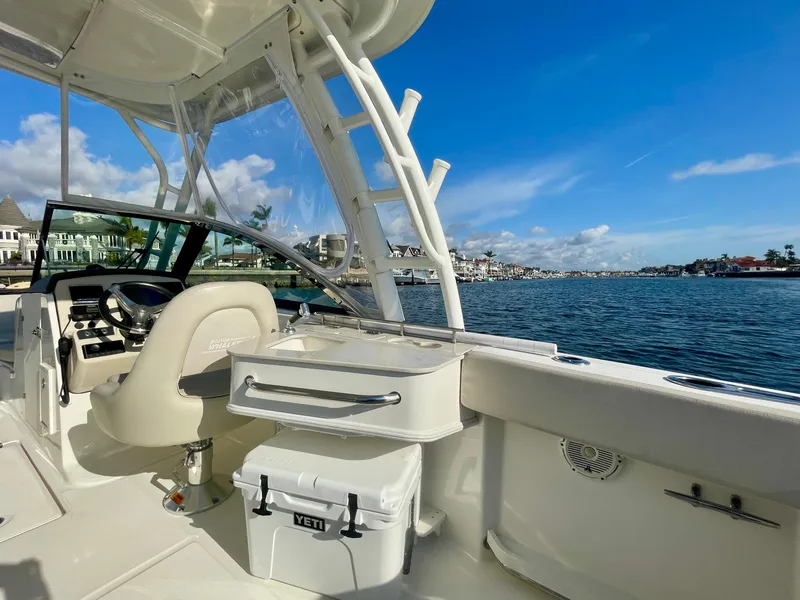 Slide: The Image of 2018 Boston Whaler 230 Vantage boat interior with helm, seating, and ocean view. - 21