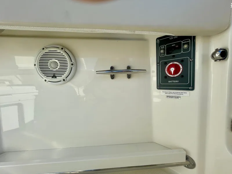 Slide: The Image of 2018 Boston Whaler 230 Vantage interior with speaker and battery switch. - 23