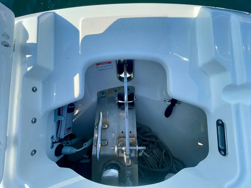 Slide: The Image of 2018 Boston Whaler 230 Vantage anchor compartment with rope and winch. - 28