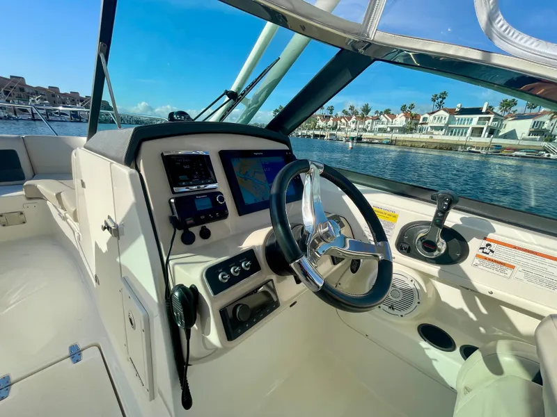 Slide: The Image of 2018 Boston Whaler 230 Vantage boat cockpit with steering wheel and navigation system. - 35