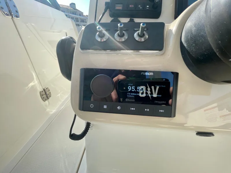 Slide: The Image of Control panel of a 2018 Boston Whaler 230 Vantage boat with radio display. - 36