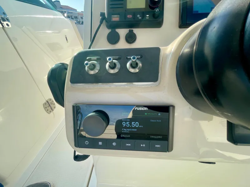 Slide: The Image of 2018 Boston Whaler 230 Vantage dashboard with radio and control panel. - 40