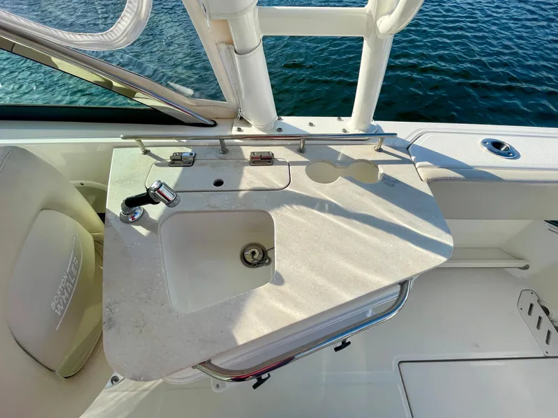 Slide: The Image of Boston Whaler 230 Vantage 2018 boat sink and countertop detail by the water. - 48