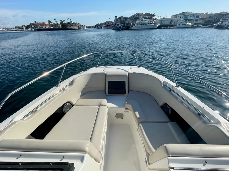 Slide: The Image of 2018 Boston Whaler 230 Vantage boat on calm water, scenic harbor view. - 8