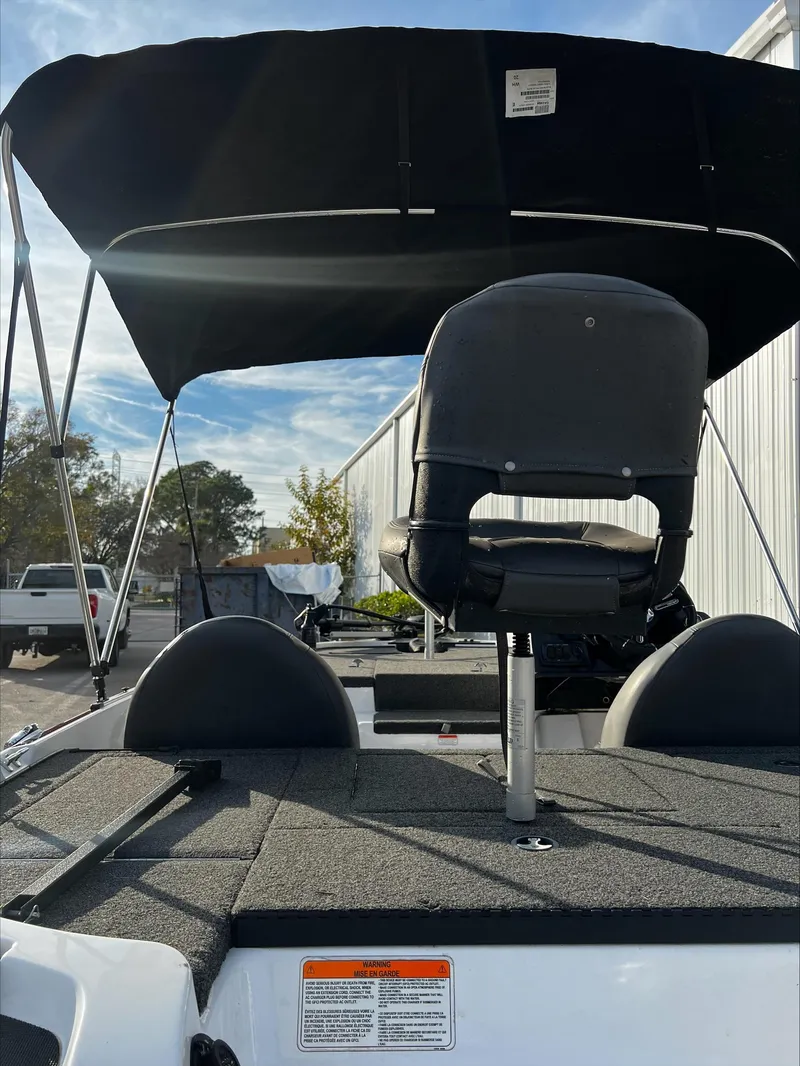 Slide: The Image of 2019 Nitro Z17 boat with canopy and seating, parked outdoors. - 5