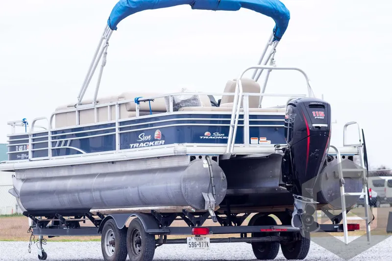 Slide: The Image of 2020 Sun Tracker Fishin' Barge 22 DLX pontoon boat on trailer, rear view. - 10