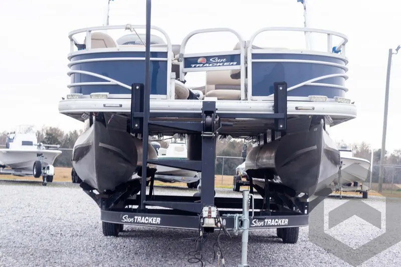 Slide: The Image of 2020 Sun Tracker Fishin' Barge 22 DLX pontoon boat on trailer, rear view. - 13