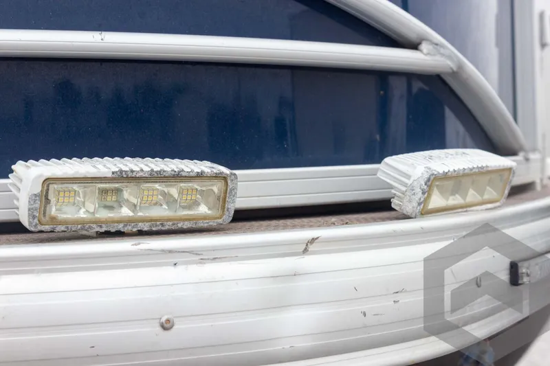 Slide: The Image of 2020 Sun Tracker Fishin' Barge 22 DLX, close-up of LED lights on blue exterior. - 27