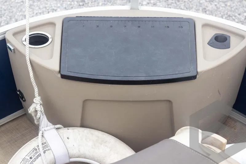 Slide: The Image of 2020 Sun Tracker Fishin' Barge 22 DLX boat interior with cutting board and cup holder. - 29