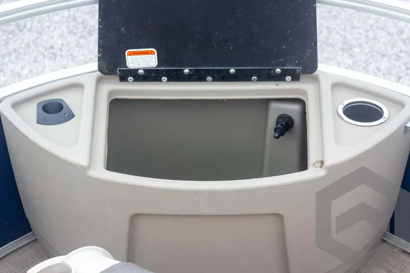 Slide: The Image of Sun Tracker Fishin' Barge 22 DLX 2020 boat storage compartment with cup holders. - 32