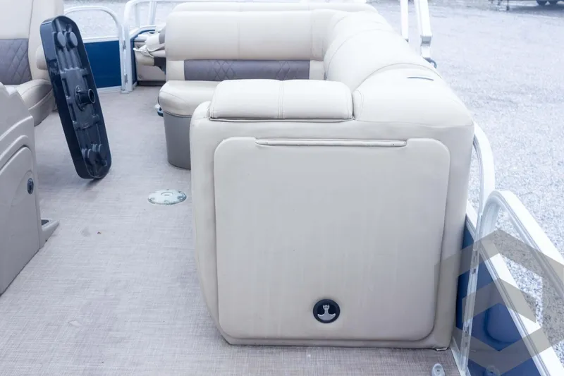 Slide: The Image of 2020 Sun Tracker Fishin' Barge 22 DLX interior with beige seating and storage. - 36