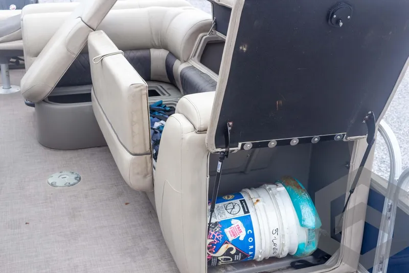 Slide: The Image of 2020 Sun Tracker Fishin' Barge 22 DLX with open storage compartment and bucket. - 37