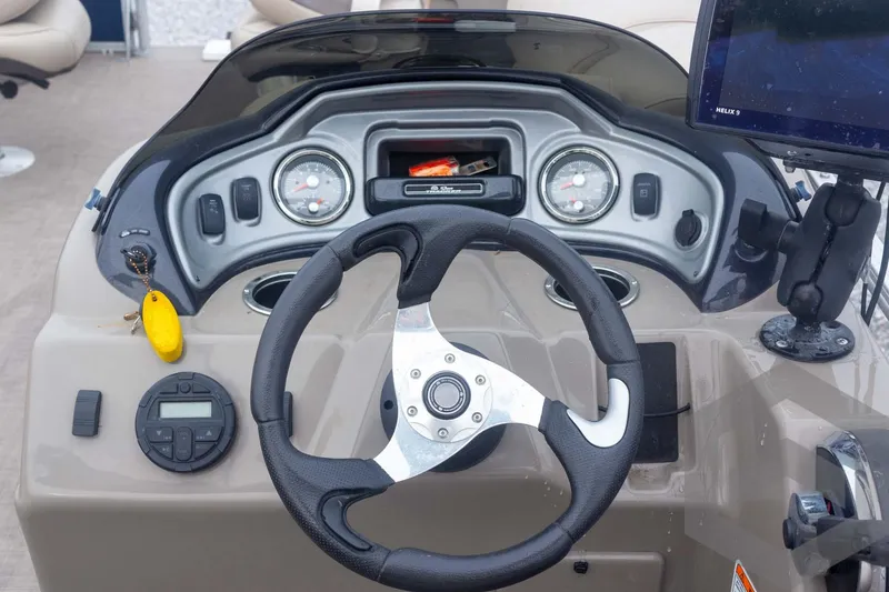 Slide: The Image of Dashboard of 2020 Sun Tracker Fishin' Barge 22 DLX with steering wheel and gauges. - 39