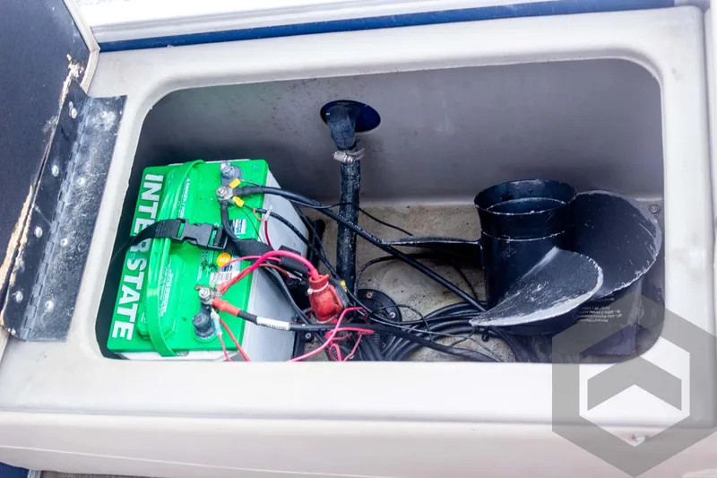 Slide: The Image of Battery compartment of 2020 Sun Tracker Fishin' Barge 22 DLX with green Interstate battery. - 49