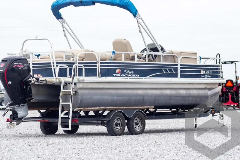 Slide: The Image of 2020 Sun Tracker Fishin' Barge 22 DLX pontoon boat on trailer, side view. - 8