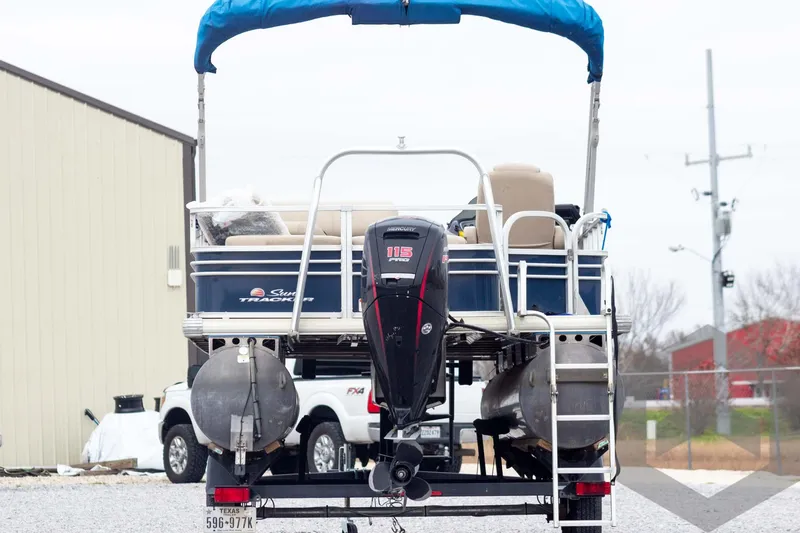 Slide: The Image of 2020 Sun Tracker Fishin' Barge 22 DLX pontoon boat with blue canopy and outboard motor. - 9