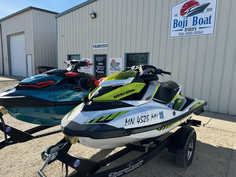 Slide: The Image of 2019 Sea-Doo RXP-X 300 jet skis on trailer outside Boji Boat Brokers. - 2