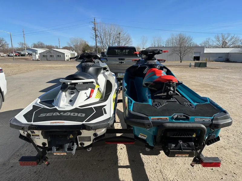 Slide: The Image of Two 2019 Sea-Doo RXP-X 300 jet skis on a trailer in a parking lot. - 5
