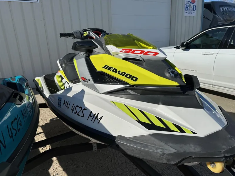 Slide: The Image of 2019 Sea-Doo RXP-X 300 jet ski with vibrant yellow accents parked outdoors. - 6