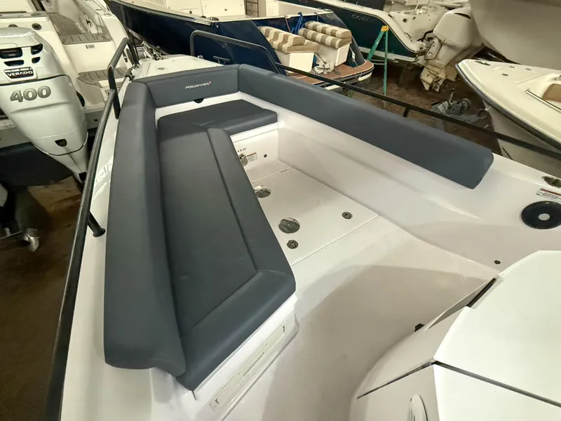 Slide: The Image of 2021 Axopar 28 CABIN boat interior with cushioned seating and modern design. - 12