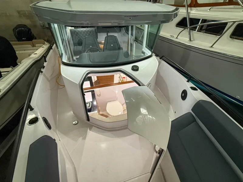 Slide: The Image of 2021 Axopar 28 CABIN boat interior with seating and cabin view. - 14