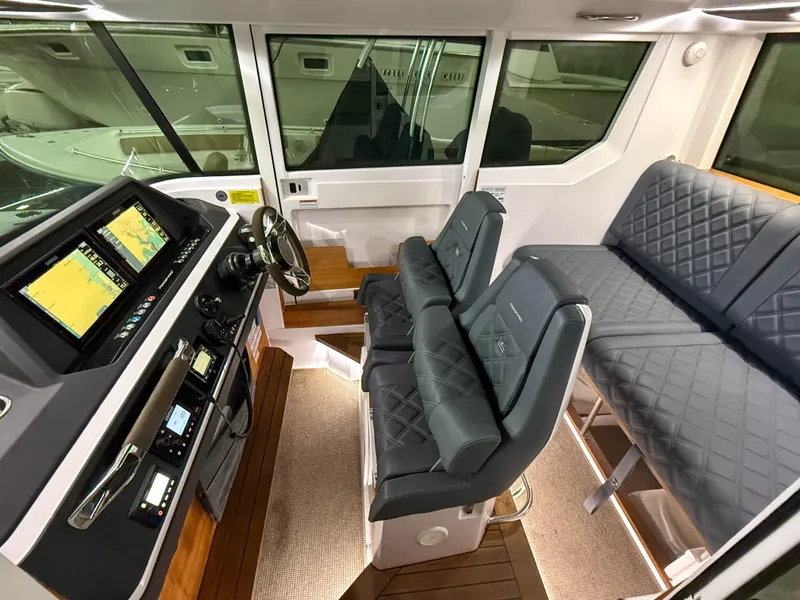 Slide: The Image of Interior of 2021 Axopar 28 CABIN boat with modern dashboard and seating. - 5