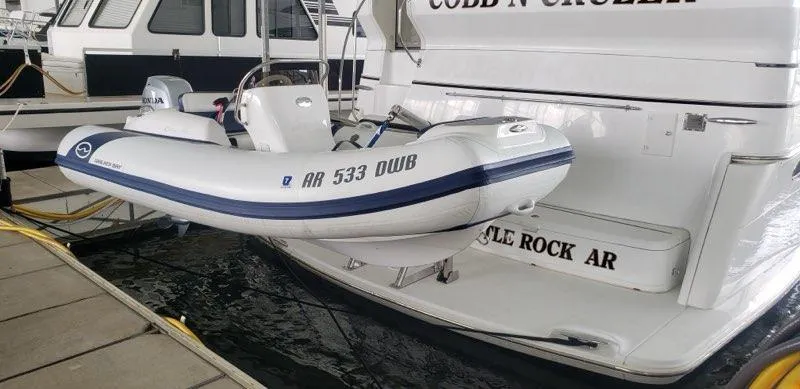 Slide: The Image of 2021 Walker Bay Generation 360 DLX inflatable boat docked beside a larger vessel. - 11