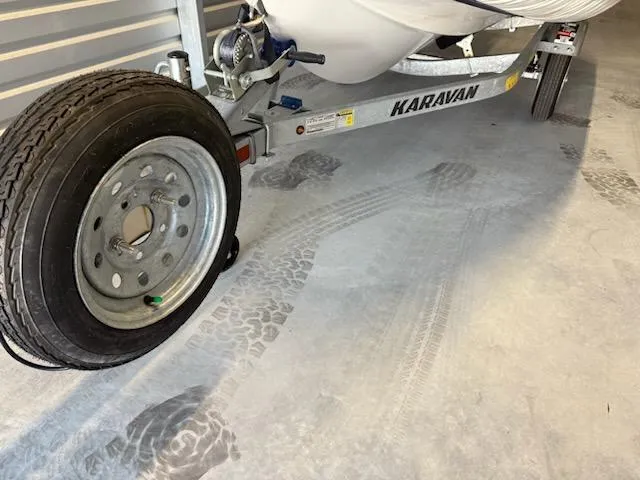 Slide: The Image of Trailer with Walker Bay Generation 360 DLX boat, 2021 model, in a garage. - 14