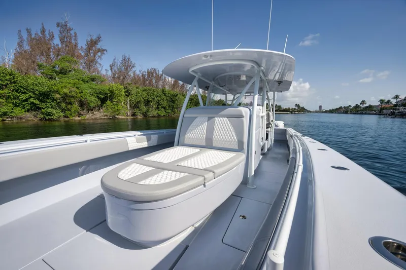 Slide: The Image of 2025 Contender 44 ST boat on calm water, featuring sleek design and comfortable seating. - 12