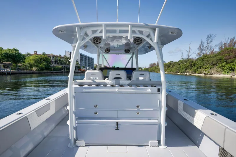 Slide: The Image of 2025 Contender 44 ST boat interior, featuring sleek design and spacious seating on a calm waterway. - 30
