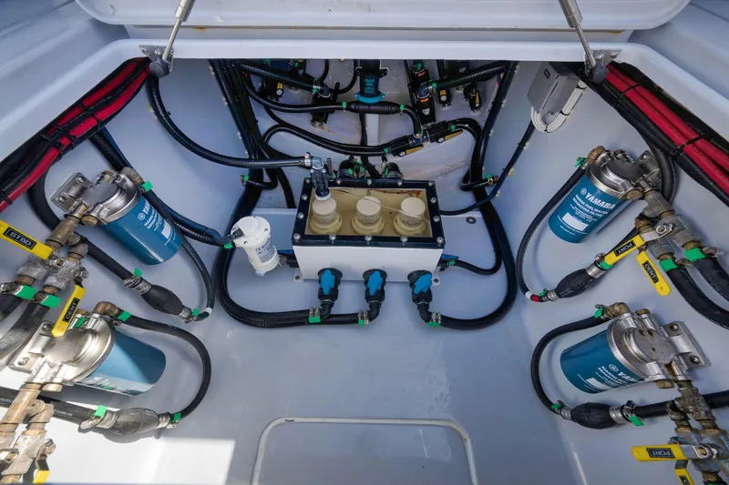 Slide: The Image of Engine compartment of 2025 Contender 44 ST, showcasing fuel filters and hoses. - 39