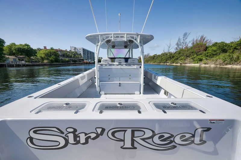 Slide: The Image of 2025 Contender 44 ST boat named "Sir' Reel" on calm water. - 42