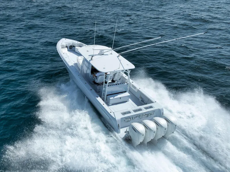 Slide: The Image of 2025 Contender 44 ST boat cruising on open water, rear view. - 43