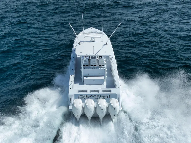 Slide: The Image of 2025 Contender 44 ST boat speeding on ocean waters, rear view. - 44