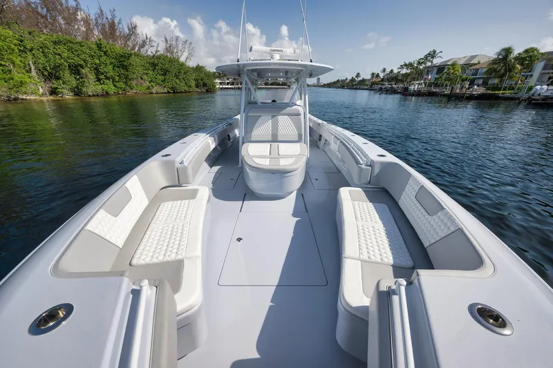 Slide: The Image of 2025 Contender 44 ST boat with spacious seating on a calm waterway. - 7