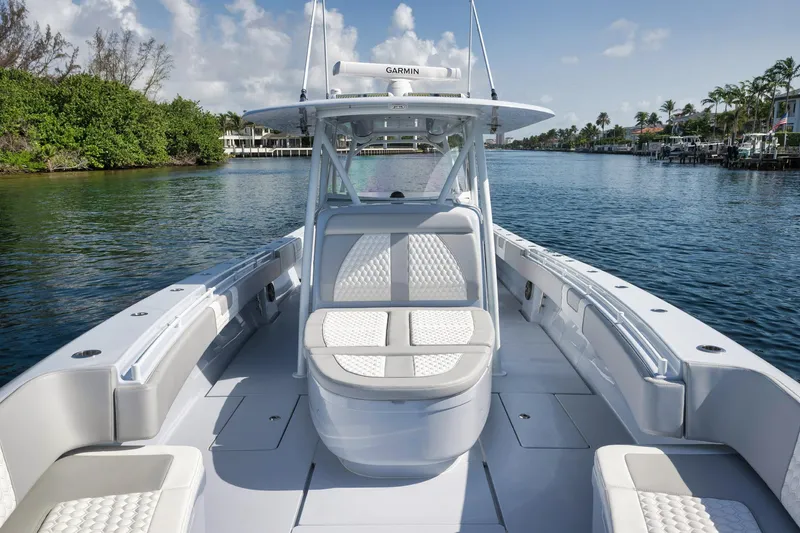 Slide: The Image of 2025 Contender 44 ST boat on a serene waterway, showcasing sleek design and comfortable seating. - 8